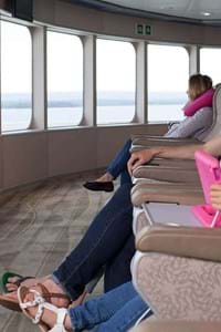 family relaxing in condor liberation horizon lounge and looking out the windows