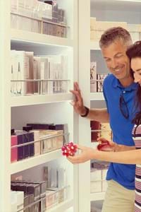 couple testing perfume in adore duty free shop