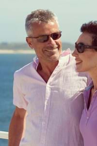 couple stood outside on deck in sunny weather