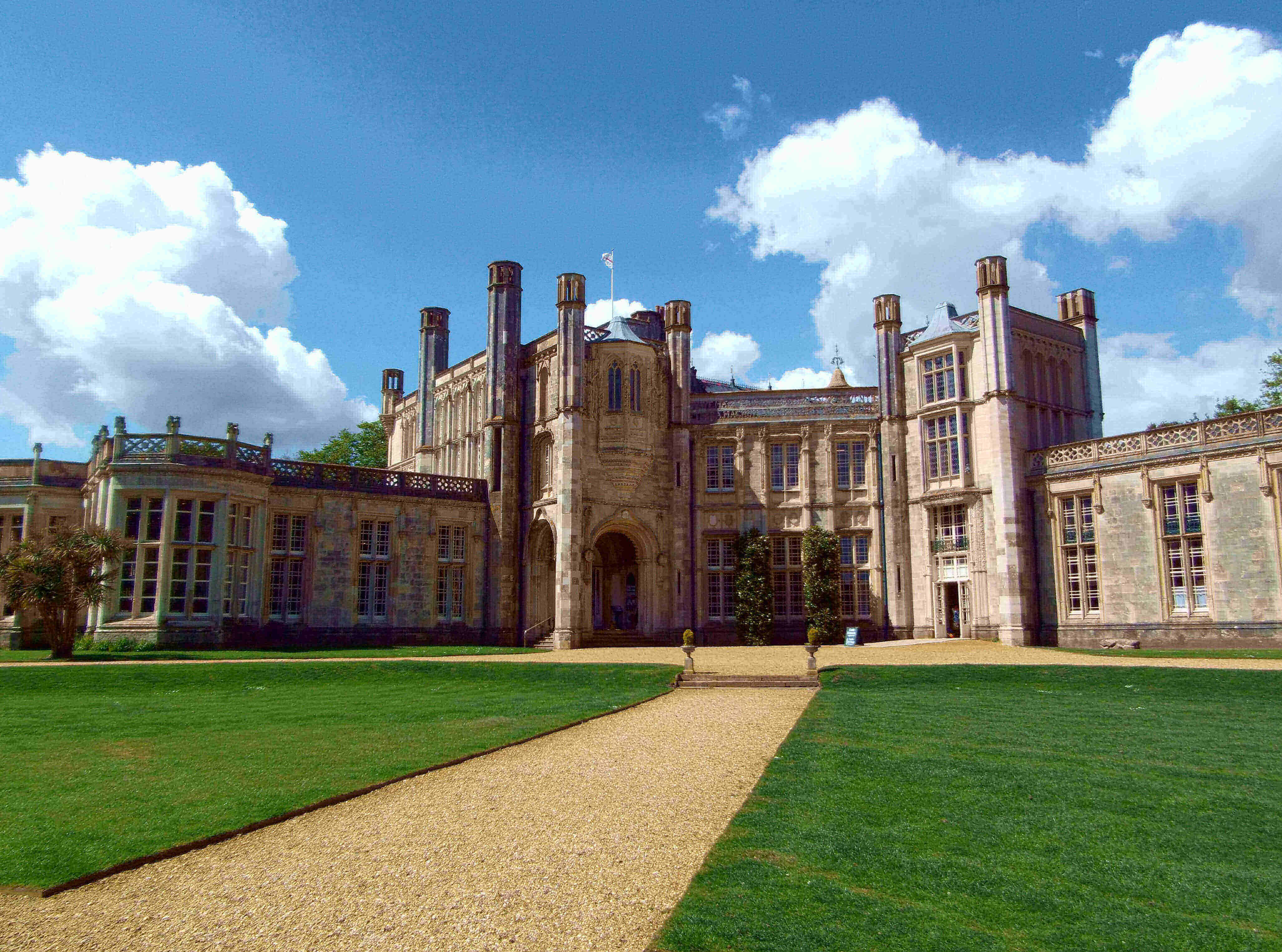 highcliffe castle dorset with blue sky and green grass