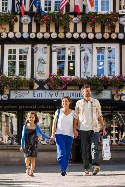 family standing infront of shops in st malo brittany