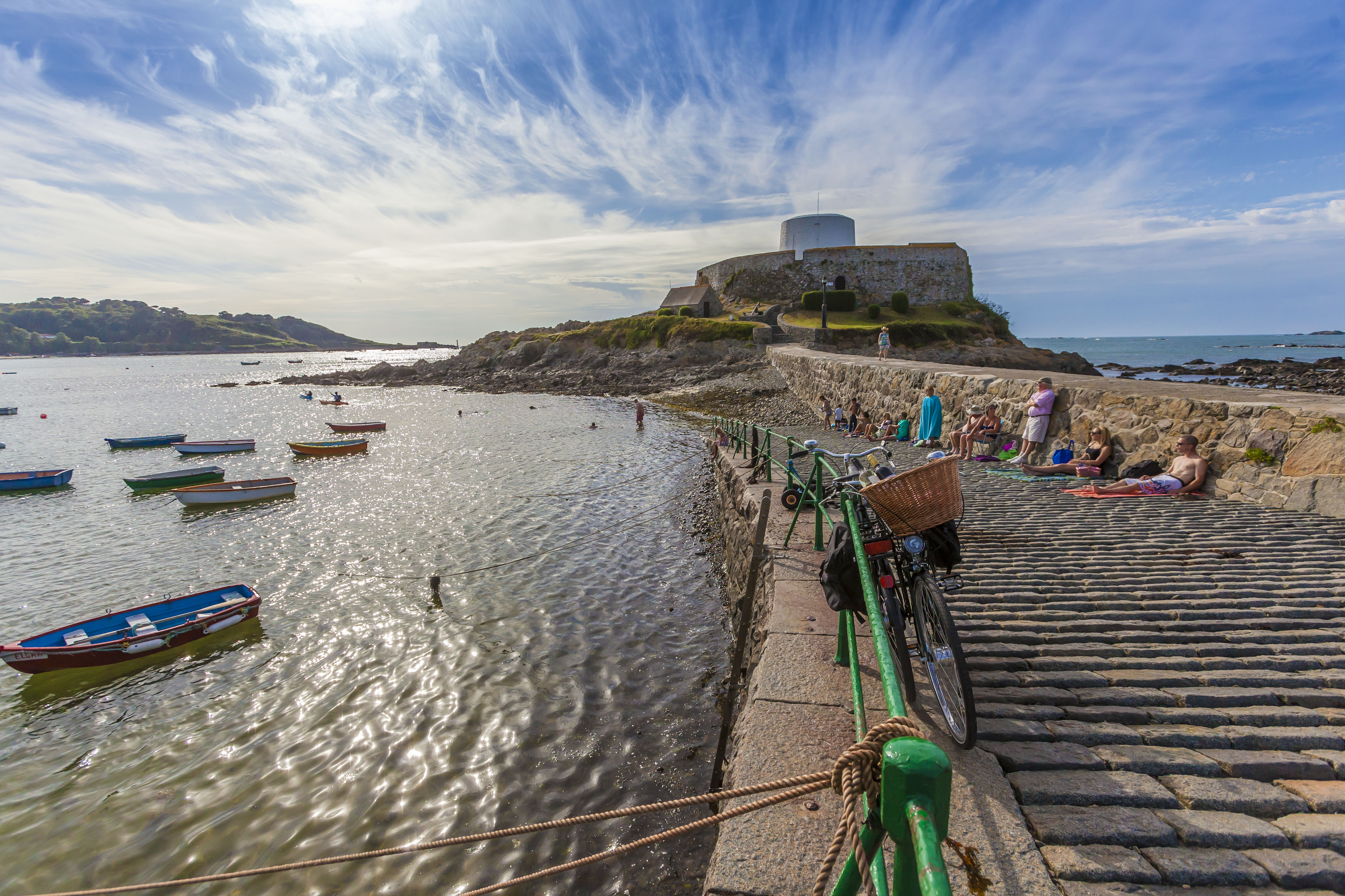 The walkway up to Castle Cornet with the sea and fishing boats on your right